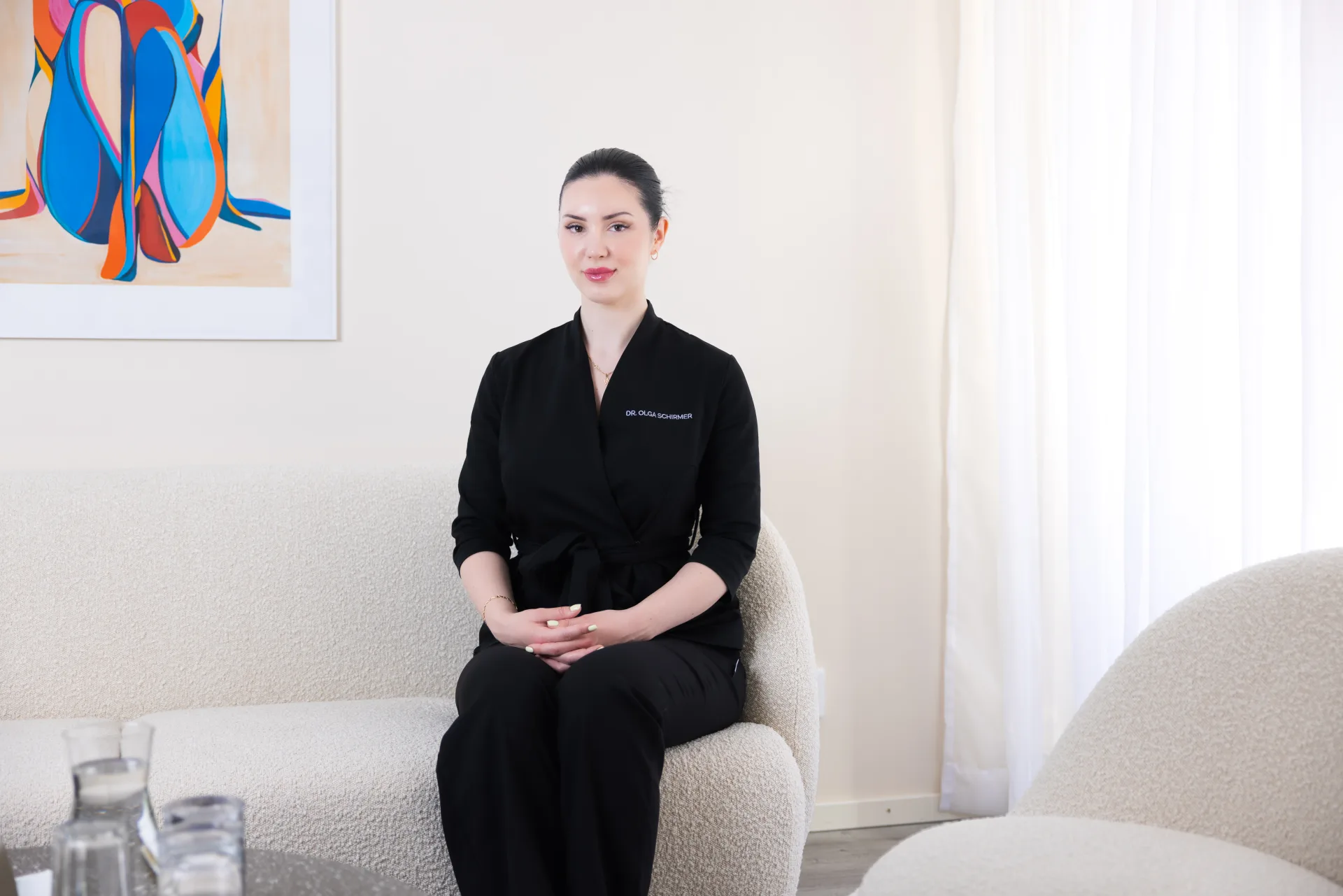 Dr. Olga Schirmer seated in the clinic’s consultation lounge